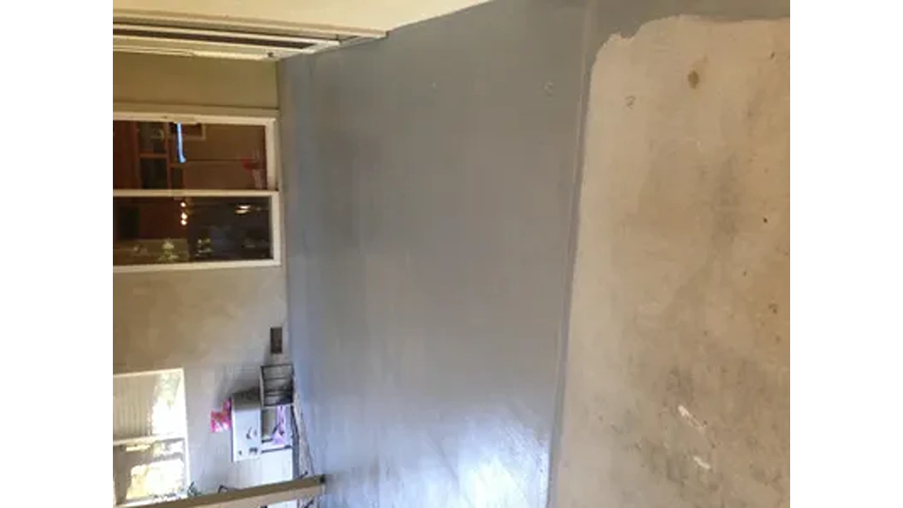 A room with a wall that has been painted.